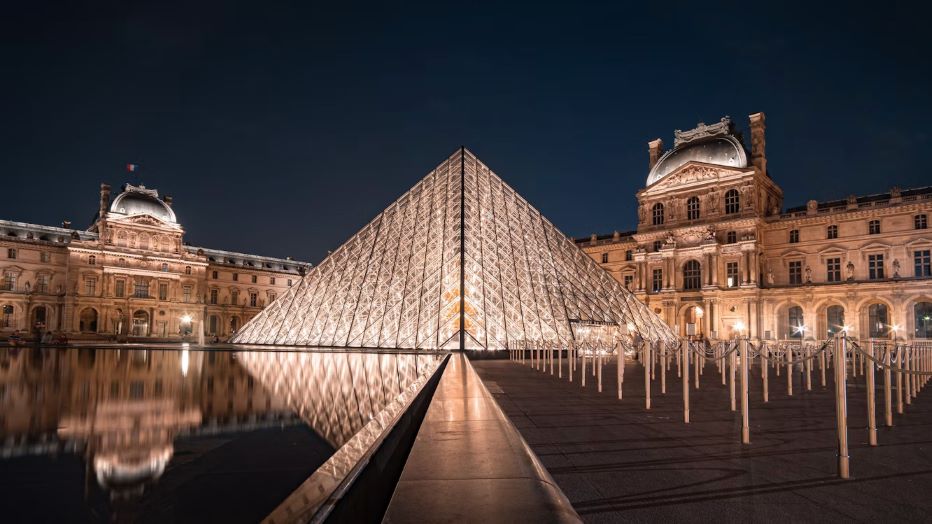 The Louvre Museum and its iconic glass pyramid in Paris